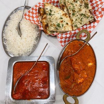 The India Restaurant signature dishes Tandoori Chicken, Lamb Rogan Josh, Saag Paneer, Garlic Naan